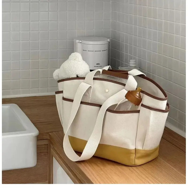 Wickeltasche für Eltern ⎜ Geräumige Tragetasche aus Canvas mit mehreren Fächern und praktischem Flaschenhalter