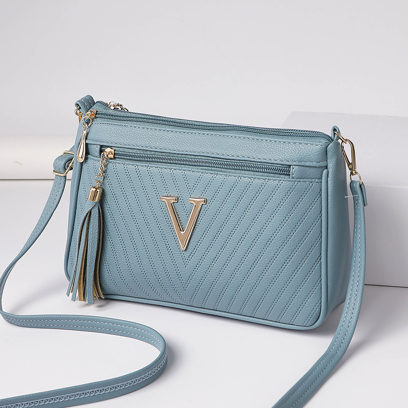 Umhängetasche für Damen ⎜ Kompakte Schultertasche mit Reißverschluss und Quaste für Alltag und Ausgehen