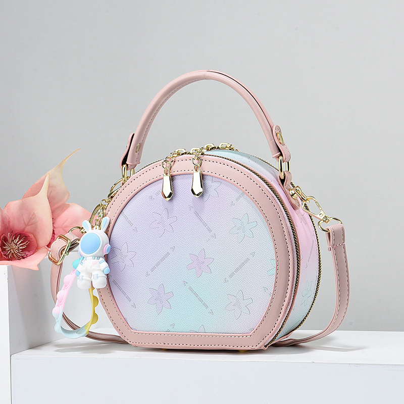 Handtasche für Damen ⎜ Runde Umhängetasche im Pastellstil mit verspieltem Anhänger für Alltag und Freizeit