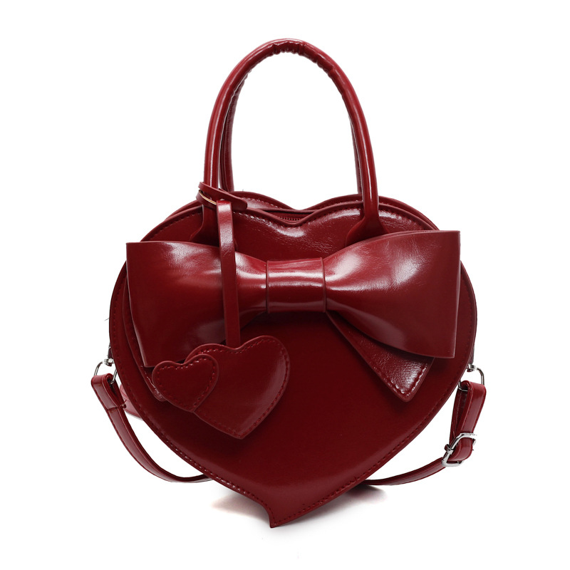 Herzförmige Umhängetasche für Damen ⎜ Verspielte Handtasche mit Schleife für Alltag und besondere Anlässe